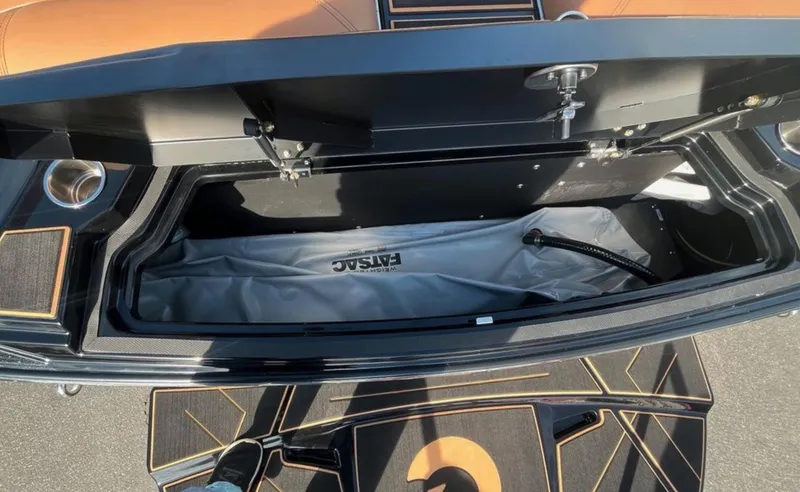 Slide: The Image of Open storage compartment of 2025 Centurion Ri 265 boat, featuring spacious interior and FASTAC system. - 12