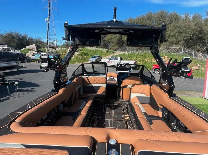 Slide: The Image of 2025 Centurion Ri 265 boat with luxurious tan interior and advanced features. - 14