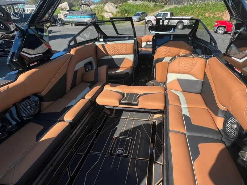 Slide: The Image of Luxurious interior of 2025 Centurion Ri 265 boat with tan and black seating. - 17