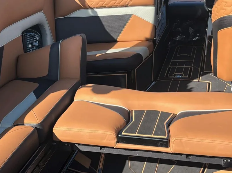 Slide: The Image of 2025 Centurion Ri 265 boat interior with luxurious tan and black seating. - 18