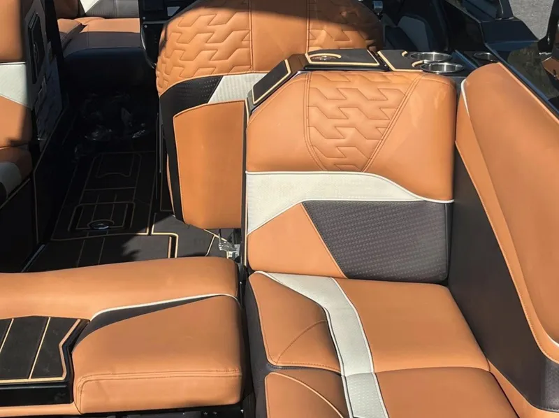Slide: The Image of Luxurious interior seating of 2025 Centurion Ri 265 boat with tan and black upholstery. - 19