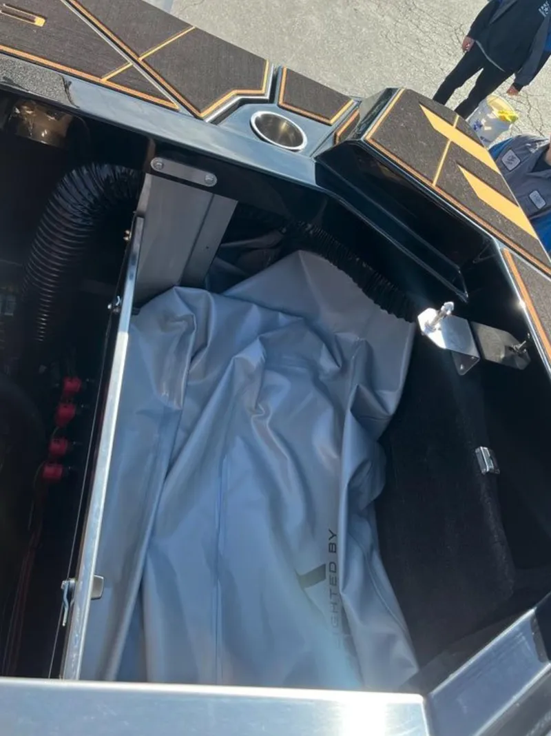 Slide: The Image of 2025 Centurion Ri 265 boat interior storage compartment with cover, showcasing sleek design and functionality. - 22