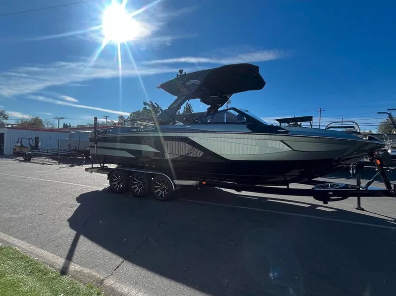 Slide: The Image of 2025 Centurion Ri 265 boat on trailer under bright sunlit sky. - 28