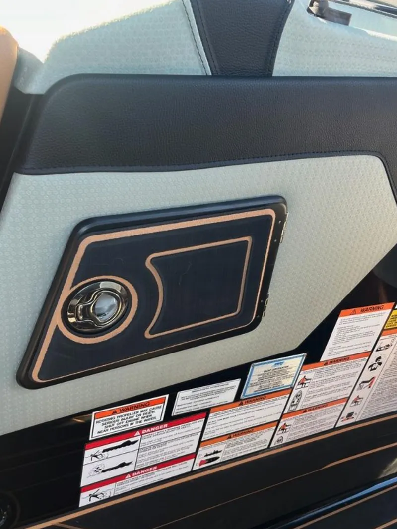 Slide: The Image of 2025 Centurion Ri 265 interior panel with control knob and safety labels. - 38