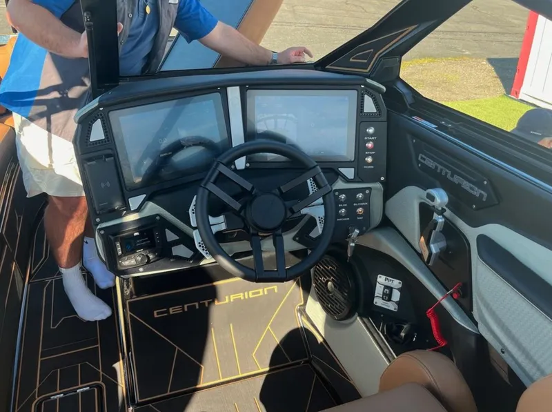 Slide: The Image of 2025 Centurion Ri 265 boat dashboard with dual screens and steering wheel. - 41