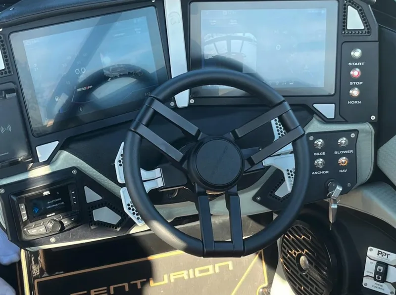 Slide: The Image of Steering wheel and dashboard of 2025 Centurion Ri 265 boat with digital displays. - 42