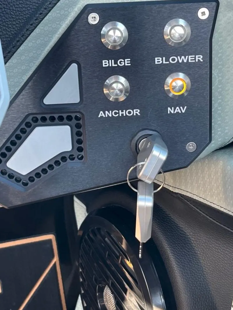 Slide: The Image of Control panel of 2025 Centurion Ri 265 boat with key and switches for bilge, blower, anchor, and navigation. - 45