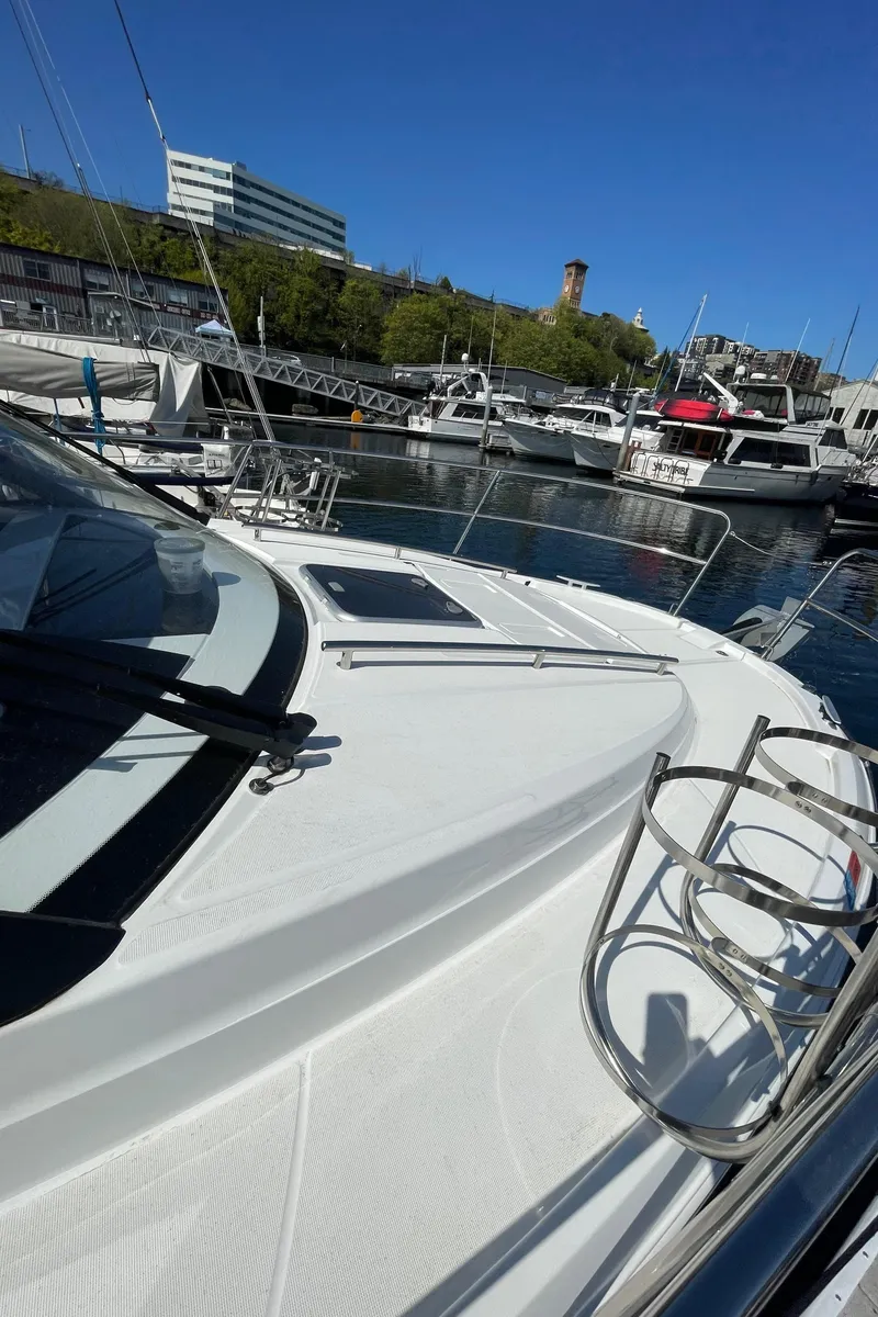 Slide: The Image of 2019 Jeanneau NC895 boat docked in a marina under clear blue sky. - 14