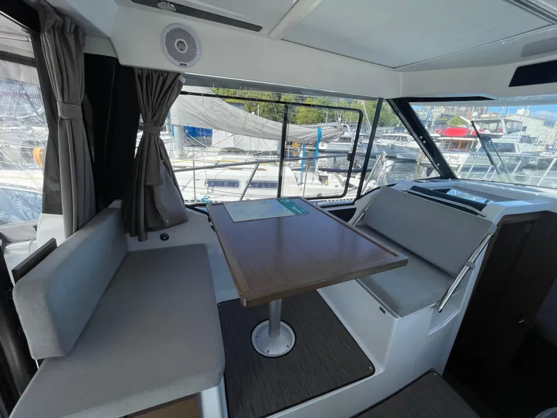 Slide: The Image of Interior of 2019 Jeanneau NC895 boat with seating and table, docked at marina. - 15