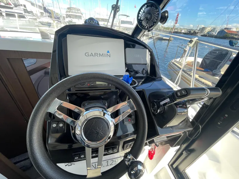 Slide: The Image of Steering wheel and controls of 2019 Jeanneau NC895 boat with Garmin navigation system. - 18
