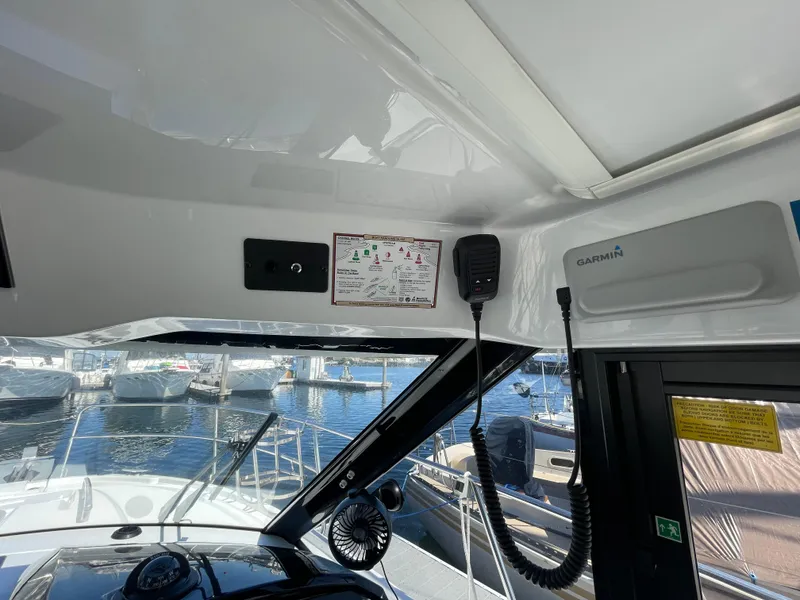 Slide: The Image of Interior view of 2019 Jeanneau NC895 boat cockpit with Garmin equipment and marina background. - 19