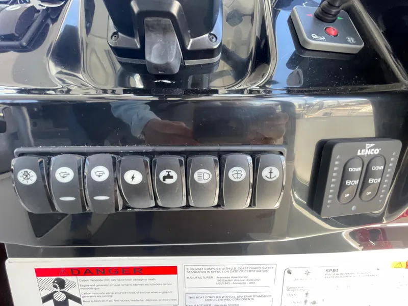 Slide: The Image of Control panel of 2019 Jeanneau NC895 boat with various switches and Lenco trim tab controls. - 20