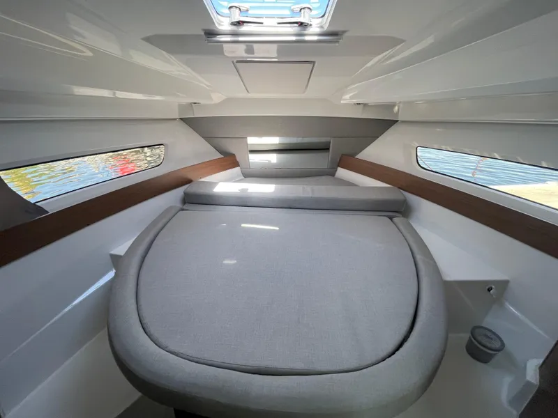 Slide: The Image of 2019 Jeanneau NC895 cabin interior with cozy bed and side windows. - 23