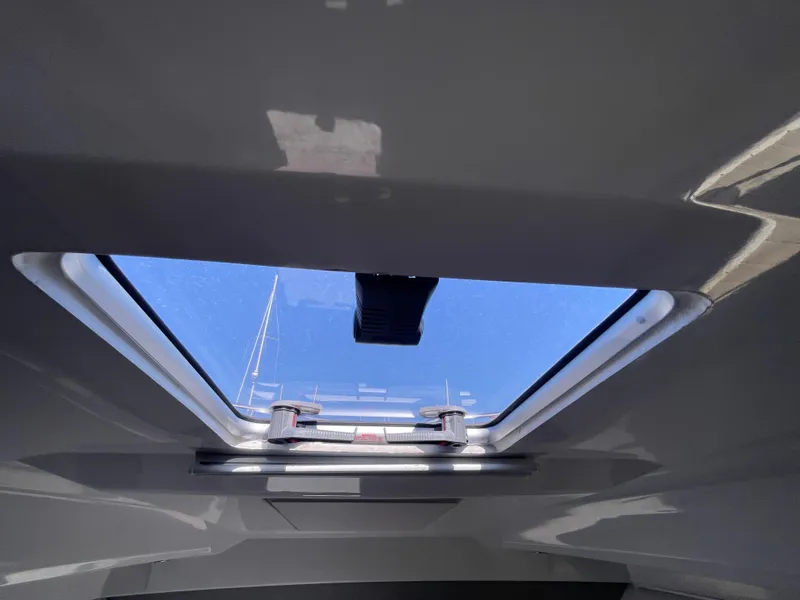 Slide: The Image of Skylight view from inside a 2019 Jeanneau NC895 boat, showcasing clear blue sky. - 26
