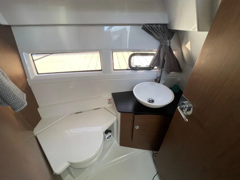 Slide: The Image of 2019 Jeanneau NC895 bathroom with modern sink, toilet, and window. - 27