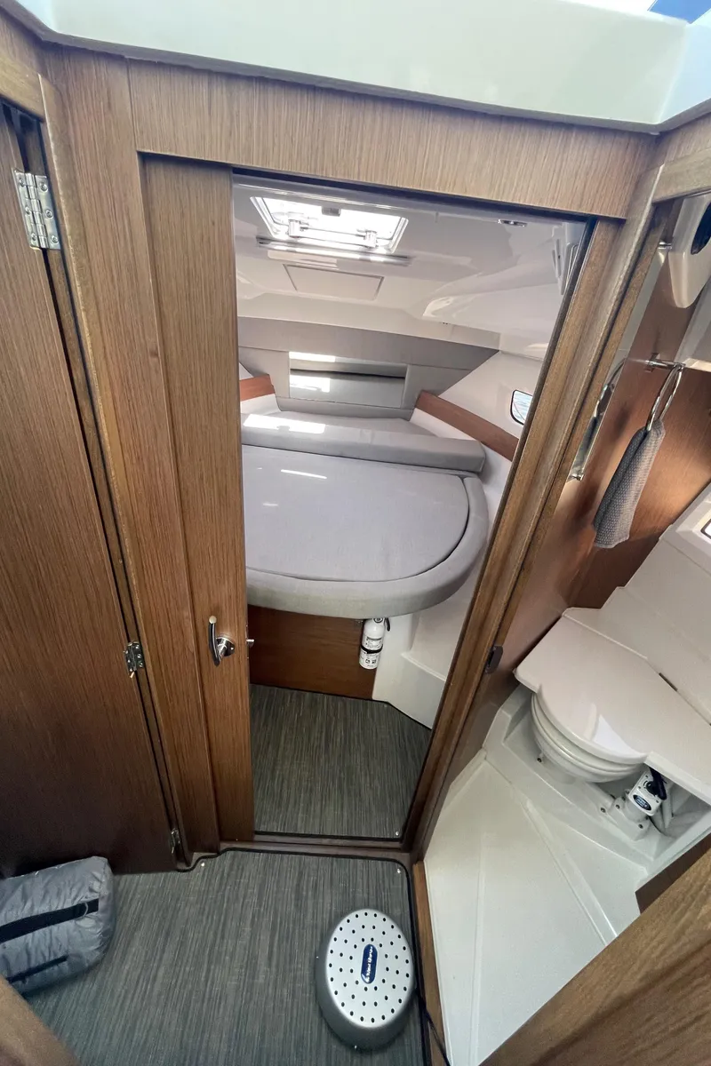 Slide: The Image of 2019 Jeanneau NC895 cabin interior with bed and compact bathroom. - 28