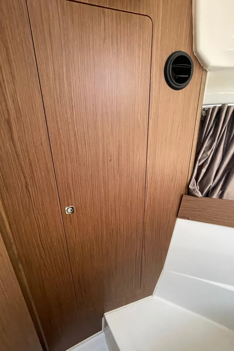 Slide: The Image of Interior of 2019 Jeanneau NC895 boat with wood paneling and seating. - 29