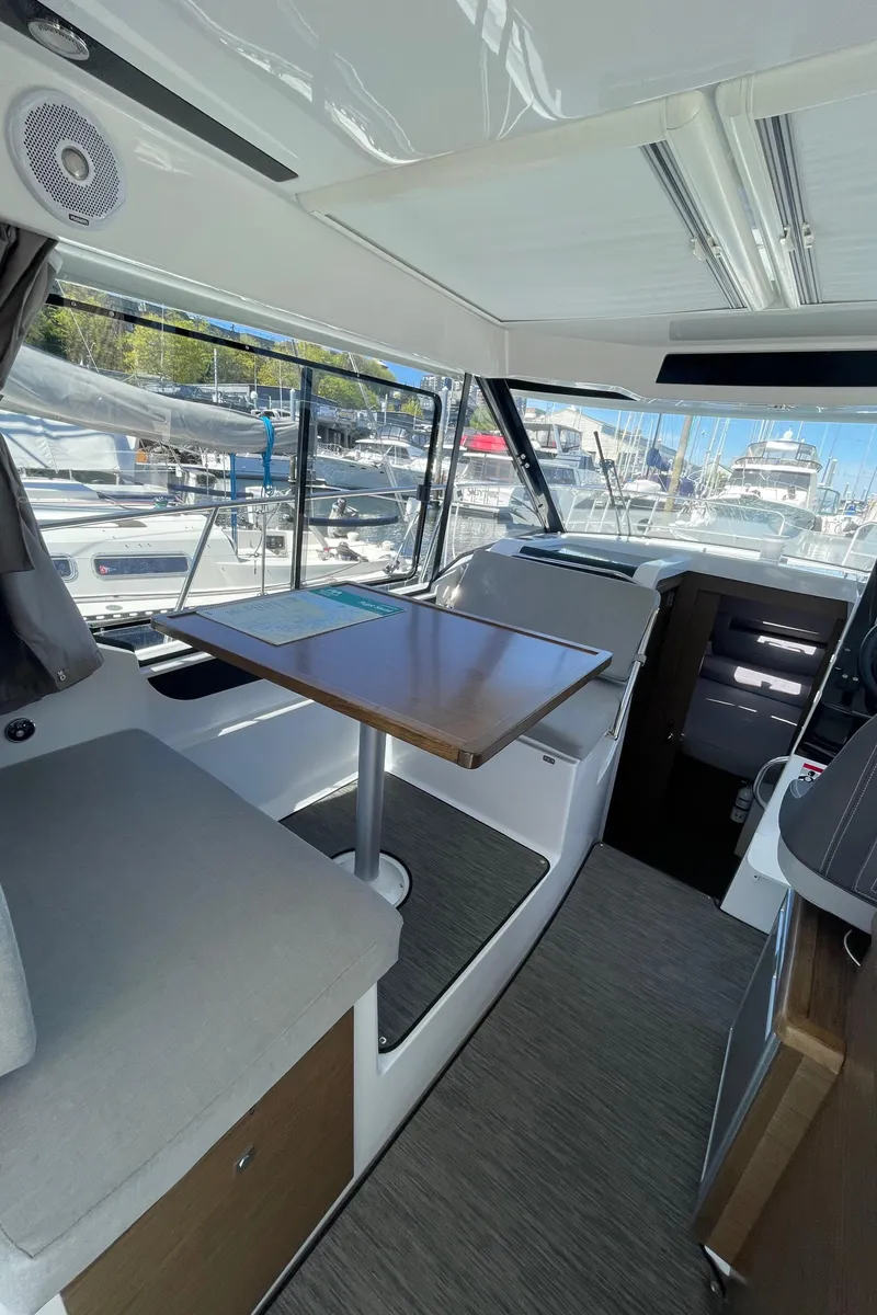 Slide: The Image of Interior of 2019 Jeanneau NC895 boat with seating and table, docked at marina. - 5