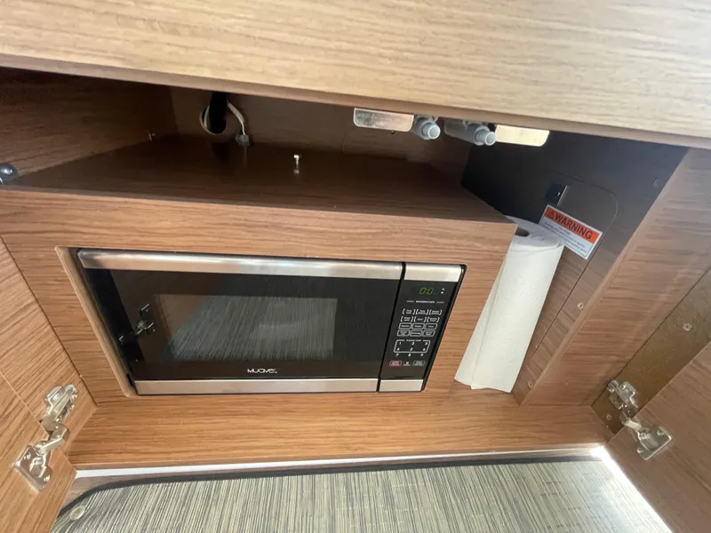 Slide: The Image of Microwave in 2019 Jeanneau NC895 boat interior kitchen area. - 7