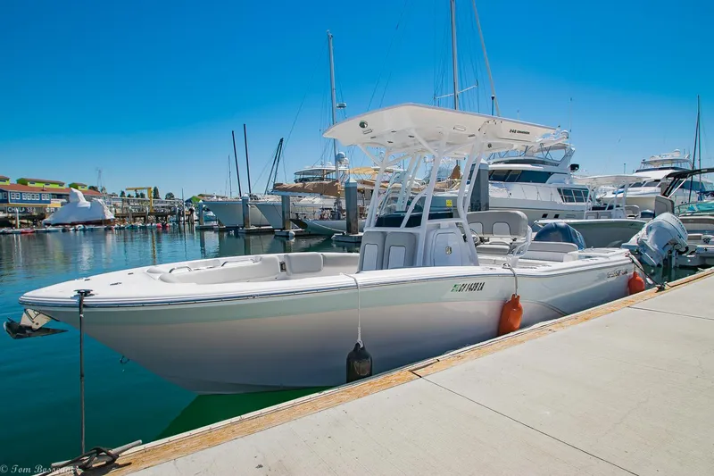The Image of 2021 Sea Fox 248 Commander boat docked at a marina under clear blue skies. - 0