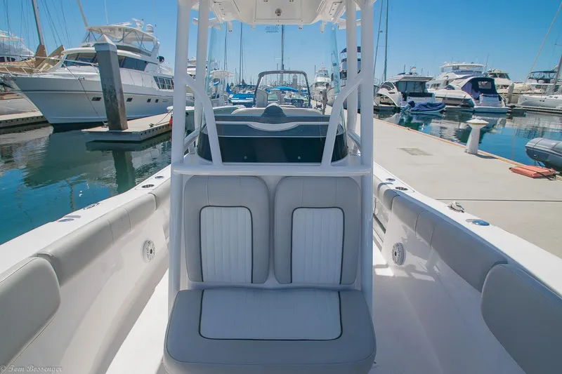 Slide: The Image of 2021 Sea Fox 248 Commander boat docked at marina, showcasing seating and helm. - 15
