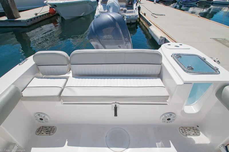 Slide: The Image of 2021 Sea Fox 248 Commander boat interior with seating and motor at dock. - 17