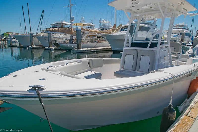 Slide: The Image of 2021 Sea Fox 248 Commander boat docked in a marina with other vessels. - 2