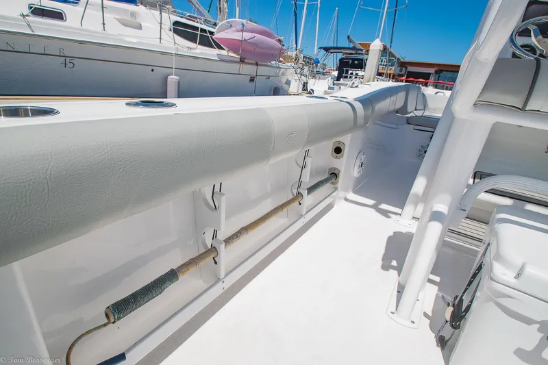 Slide: The Image of 2021 Sea Fox 248 Commander boat interior with rod holders and seating, docked at marina. - 23