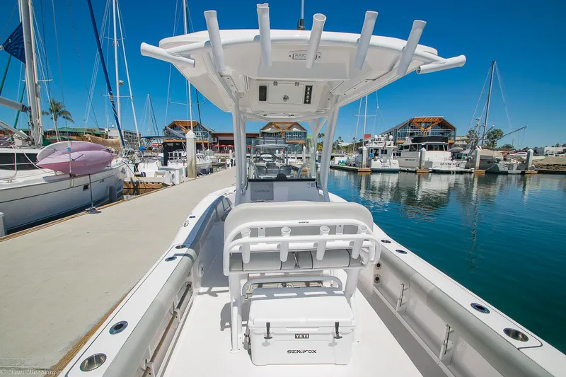 Slide: The Image of 2021 Sea Fox 248 Commander boat docked at marina, showcasing spacious deck and seating. - 4