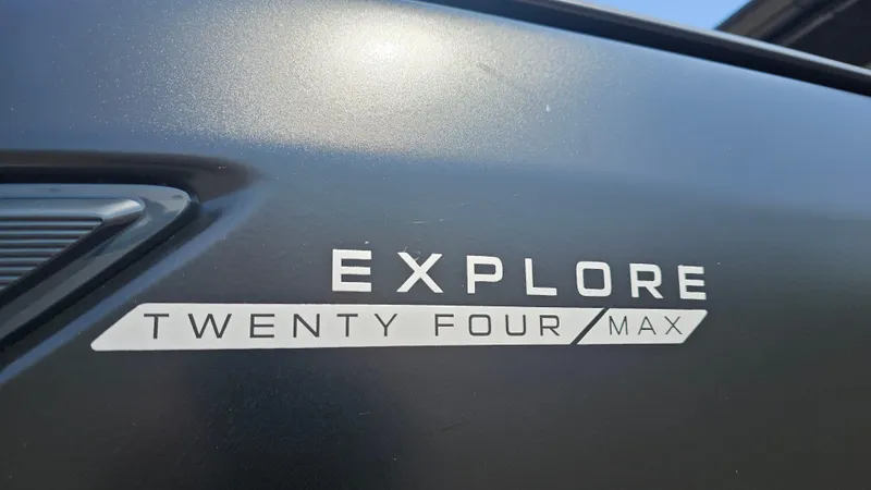 Slide: The Image of 2025 Manitou 24' Explore MAX Deck Navigator branding detail. - 16