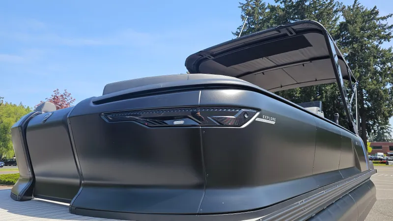 Slide: The Image of 2025 Manitou 24' Explore MAX Deck Navigator with 150hp Rotax Stealth Motor, sleek design. - 17