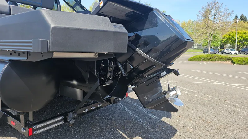 Slide: The Image of 2025 Manitou 24' Explore MAX Deck Navigator with 150hp Rotax Stealth Motor in parking lot. - 19