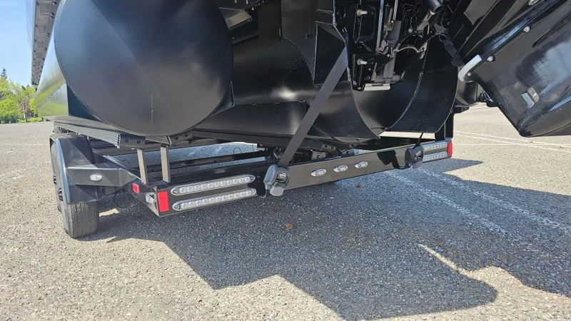 Slide: The Image of 2025 Manitou 24' Explore MAX Deck Navigator trailer view with 150hp Rotax Stealth Motor. - 21