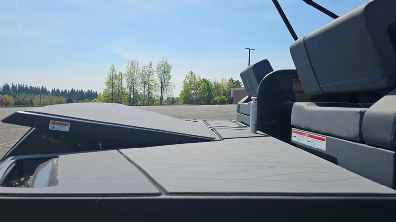 Slide: The Image of 2025 Manitou 24' Explore MAX Deck Navigator with 150hp Rotax Stealth Motor, outdoor setting. - 23