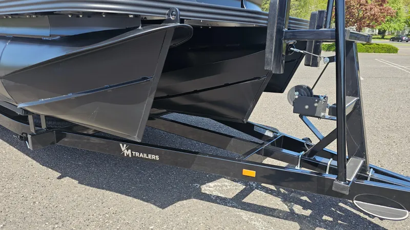 Slide: The Image of 2025 Manitou 24' Explore MAX Deck Navigator on trailer, featuring 150hp Rotax Stealth Motor. - 25