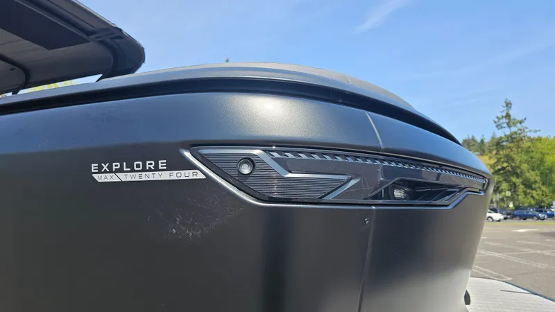 Slide: The Image of 2025 Manitou 24' Explore MAX Deck Navigator, sleek design with 150hp Rotax Stealth Motor. - 26