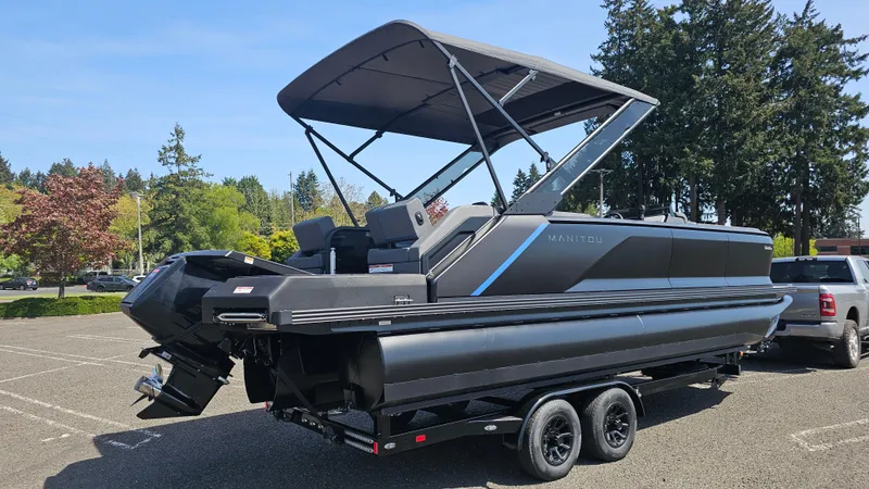 Slide: The Image of 2025 Manitou 24' Explore MAX Deck Navigator with 150hp Rotax Stealth Motor in parking lot. - 3