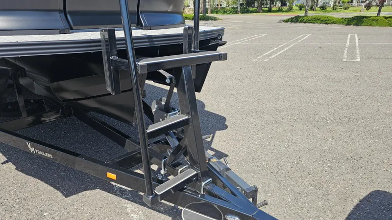 Slide: The Image of 2025 Manitou 24' Explore MAX Deck Navigator trailer with ladder in parking lot. - 33