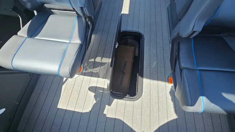 Slide: The Image of 2025 Manitou 24' Explore MAX Deck interior with storage compartment and sleek seating. - 39