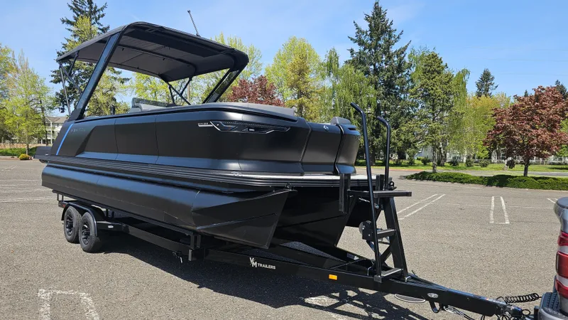 Slide: The Image of 2025 Manitou 24' Explore MAX Deck Navigator with 150hp Rotax Stealth Motor on trailer. - 4