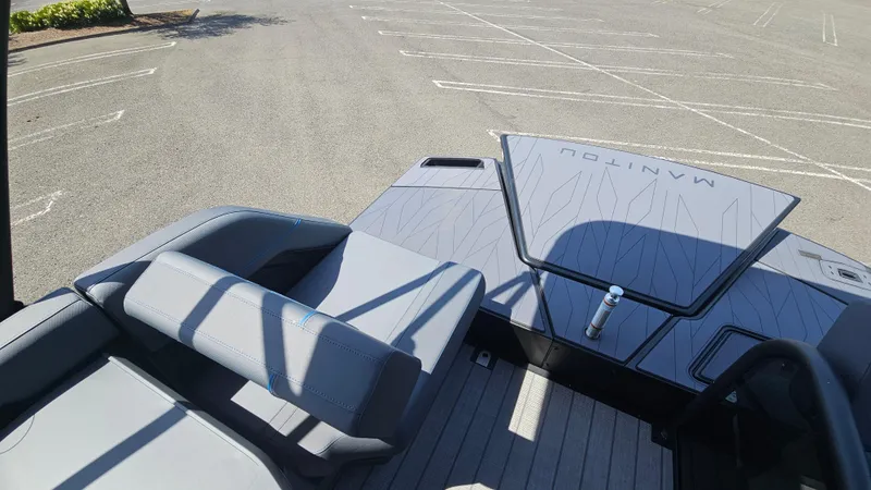 Slide: The Image of 2025 Manitou 24' Explore MAX Deck Navigator with 150hp Rotax Stealth Motor, parked in lot. - 44
