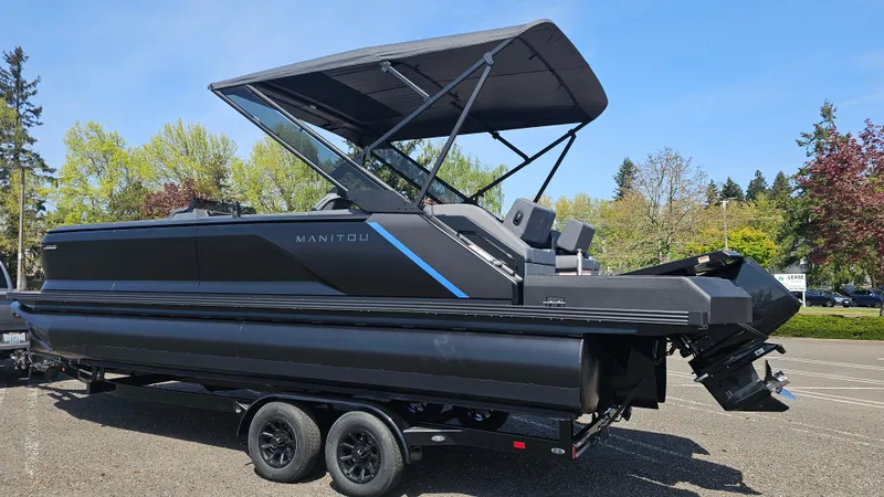 Slide: The Image of 2025 Manitou 24' Explore MAX Deck Navigator with 150hp Rotax Stealth Motor on trailer. - 5