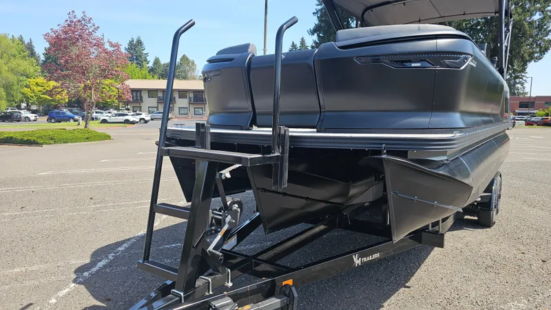 Slide: The Image of 2025 Manitou 24' Explore MAX Deck Navigator with 150hp Rotax Stealth Motor on trailer. - 9