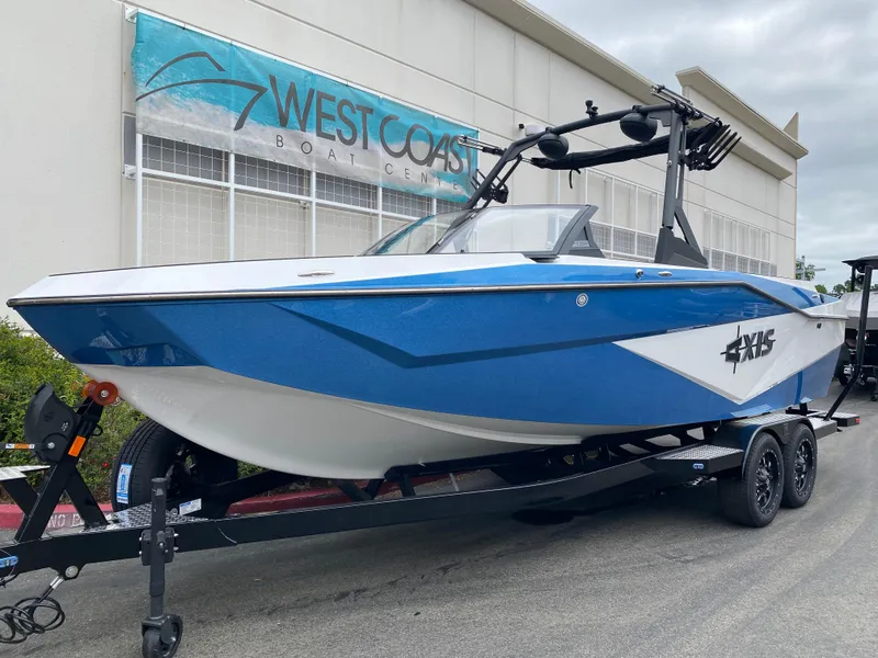 The Image of 2025 Axis T250 boat in blue and white on trailer at West Coast Boat Center. - 0