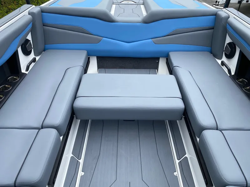 Slide: The Image of 2025 Axis T250 boat interior with blue and gray seating, showcasing modern design and comfort. - 11