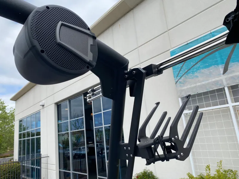 Slide: The Image of 2025 Axis T250 boat speaker and wakeboard rack against a modern building backdrop. - 13