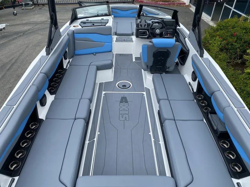 Slide: The Image of 2025 Axis T250 boat interior with gray and blue seating, spacious layout. - 8