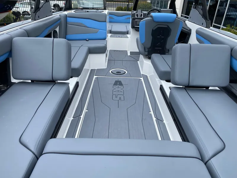 Slide: The Image of 2025 Axis T250 boat interior with gray and blue seating, modern design. - 9