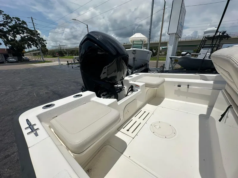 Slide: The Image of 2022 Boston Whaler 170 Montauk boat interior with motor, seats, and storage compartments. - 11