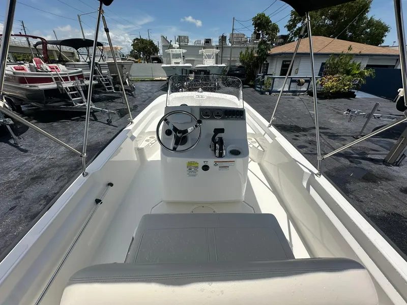 Slide: The Image of 2022 Boston Whaler 170 Montauk boat interior with steering console and seating. - 13